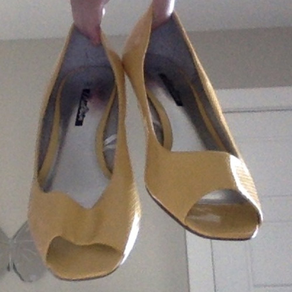 yellow heels with an opening at the bottom
